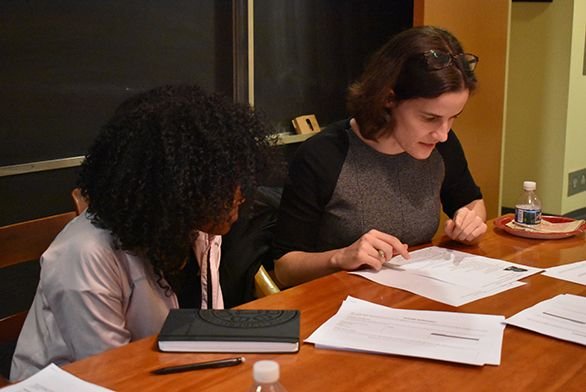 Freshman Gabriela Santana, left, looks over her resume with alumna Thea Chimento (A10)