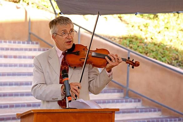 Tutor Cary Stickney (A75) plays the violin at Homecoming.