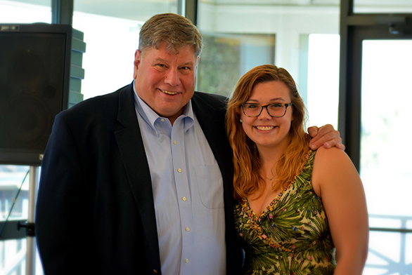 President Chris Nelson stands with senior Ashleigh Mierau at the luncheon.