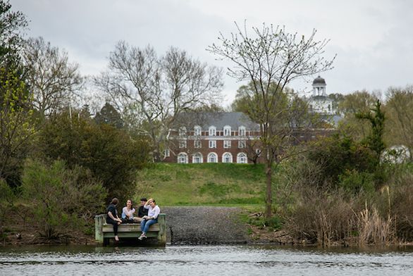 Students talking on dock by College Creek