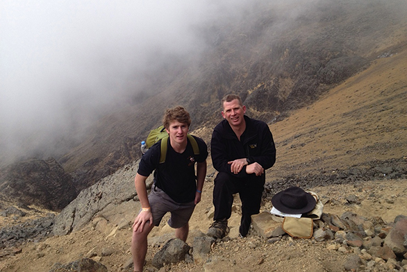 Tristan Janes (left) and his father, Jason Janes, stand on the volcano as they tried to summit it several years ago.