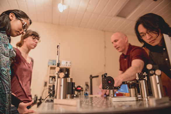 Mark Daly (second from right) goes over equipment in the new laboratory with students.