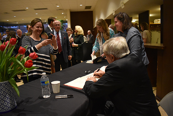 Brokaw signs autographs after the event.