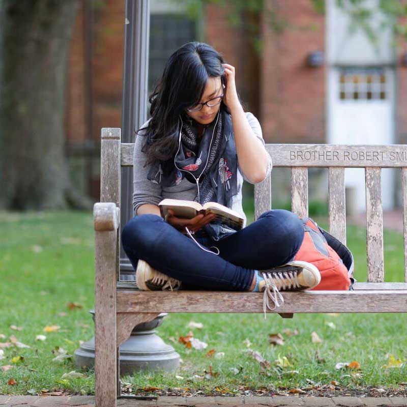 Annapolis student reading outside