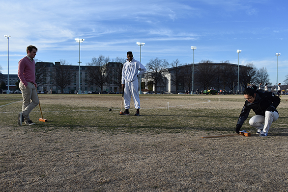 Members of the St. John's and Naval Academy croquet teams play on Naval Academy grounds.