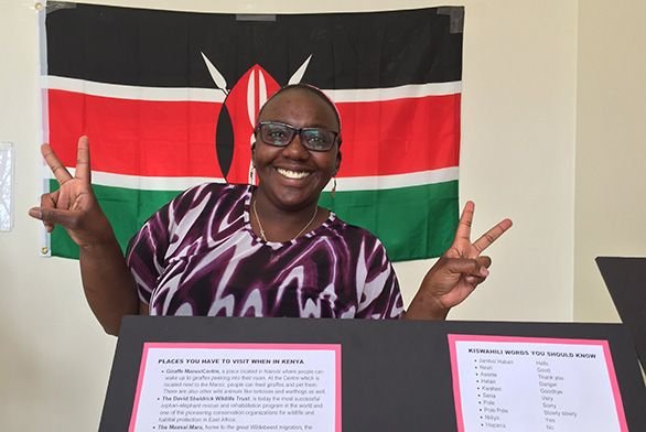 Emma Seba (SF20) poses in front of the Kenyan flag.