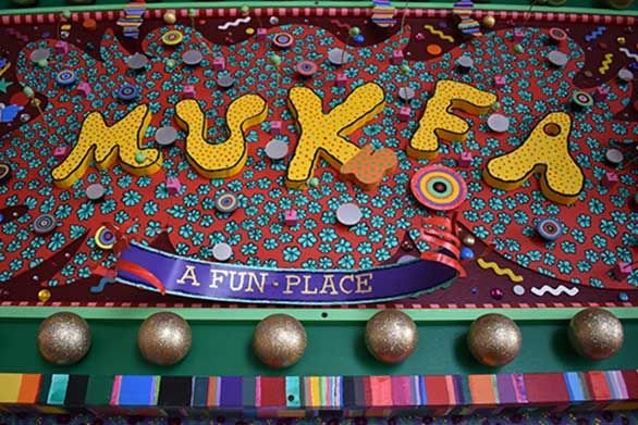 A gate welcomes visitors to Mukfa, "A Fun Place"