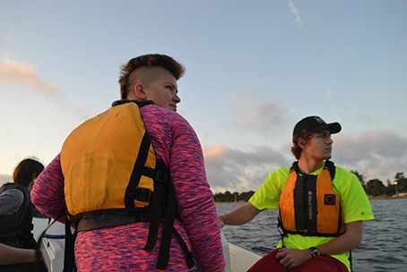 MaryEllen Markuske and Jake Cooper watch the Crew team row.