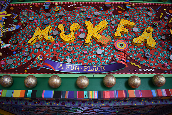 A gate welcomes visitors to Mukfa, "A Fun Place"