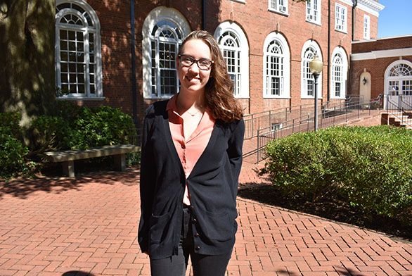 Zoe Collins stands outside Randall Hall