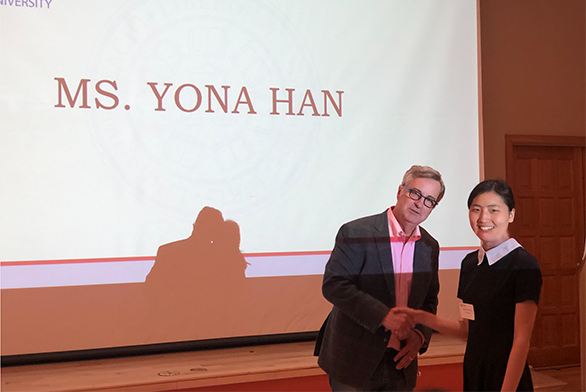 Yona Han shakes hands with President Mark Roosevelt