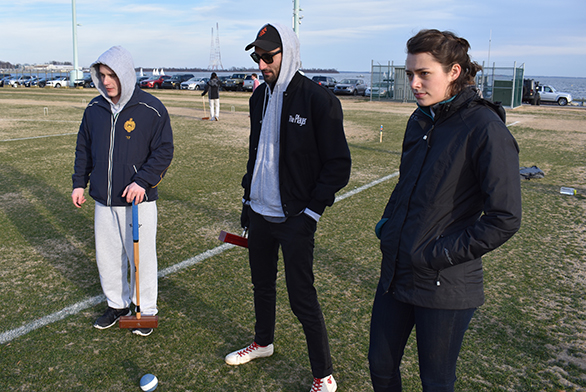 Members of the Naval Academy and St. John's croquet teams hang out at the Academy during a friendly match.