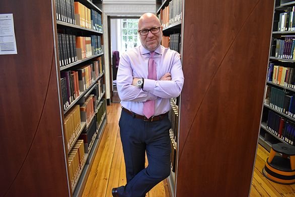 Panayiotis (Peter) Kanelos, the new president of St. John's College in Annapolis, stands in Greenfield Library.