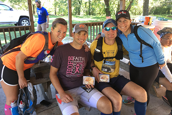 Summer and Gary Vaughn sit with Carter (second from right) and Carter's wife, Nicole, at an ultra-marathon.