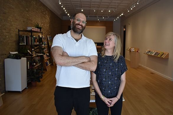 Devin King (SF03) and Caroline Picard (A02) stand in The Green Lantern Press and Gallery.