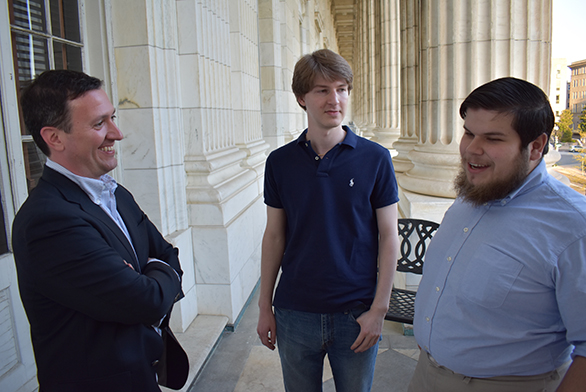 Alumnus Brian McGuire (A96), left, speaks with students Matthew Voges and Morgan Anastasi.