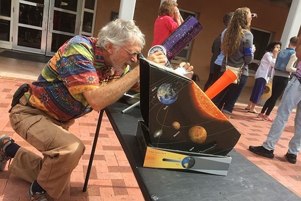 Tutor emeritus Bill Donahue sets up two telescopes, including a projection telescope, in preparation for the solar eclipse in Santa Fe.