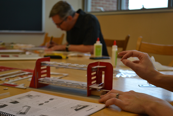 Group members work on mechanical computers.