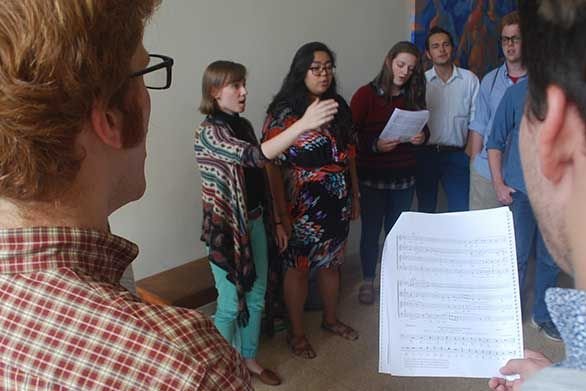 Maura Sugg leads St. John's students in the singing of Sicut Cervus