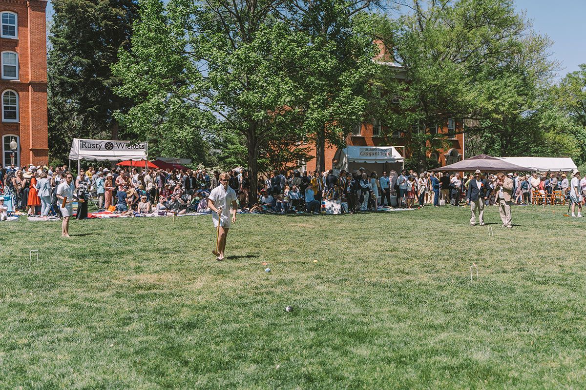 Students are playing croquet on the front lawn