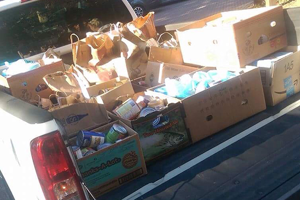 A truck full of canned goods awaits delivery to the Light House shelter.