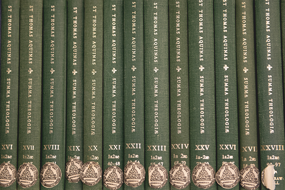 Books by St. Thomas Aquinas line a shelf in the Greenfield Library.