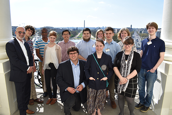 St. John's students stand on a balcony overlooking the Washington Monument.